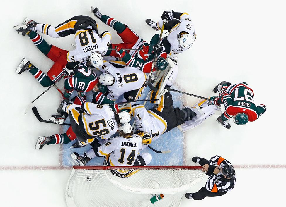 Players from the Pittsburgh Penguins defend against the New Jersey Devils late in the third period at the Prudential Center on 20 March 2021 in Newark, New Jersey.