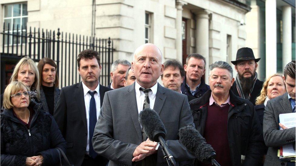 Edward Barnard talks to the press as Relatives of Glenanne make their way out of the High Court in Belfast