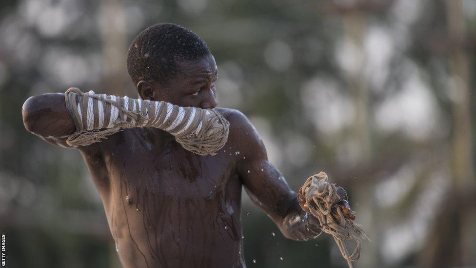 A young Dambe boxer covers himself with water after a fight in the Dambe Warriors Tournament held in Lagos on March 2, 2018. Dambe, a brutal style of fighting where one wrapped fist is a designated spear and the other a shield, is traditionally practised by Hausas in Nigeria's north, but on this night the fight was in the southern city of Lagos. The attempt to introduce Dambe to the megacity's elite was notable less for the fighting than as a showcase of Nigeria's complexity.