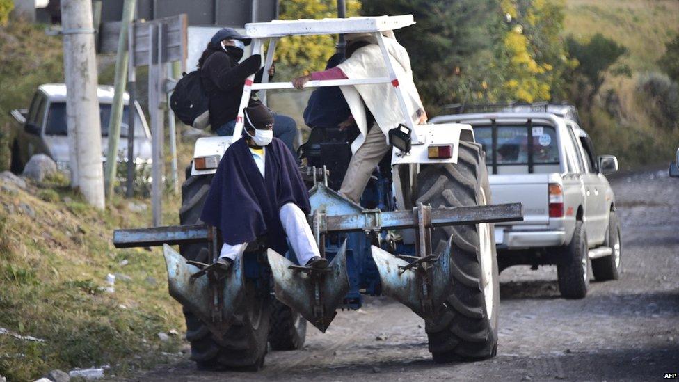 Residents of El Pedregal village evacuate on Saturday after Cotopaxi volcano increased its activity