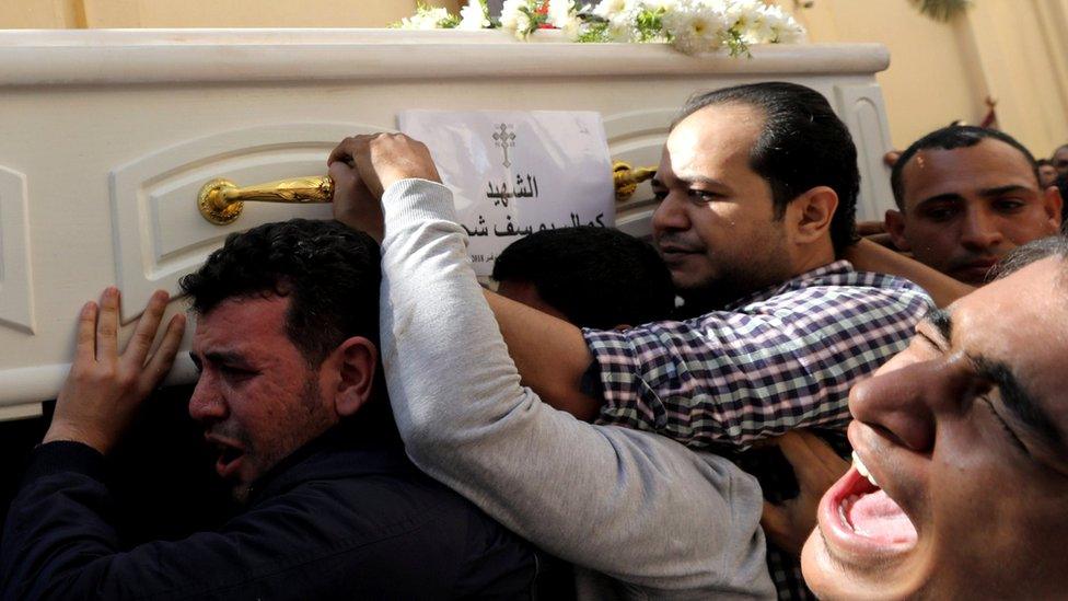 Mourners carry a coffin during the funeral of Coptic Christians who were killed in an attack, in Minya, Egypt November 3, 2018