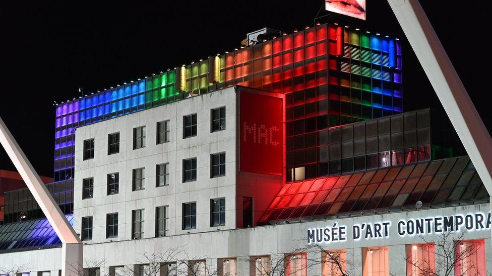 Montreal's museum of modern art is seen on April 11, 2020, illuminated in the colours of the rainbow as a sign of hope and in support of victims of the coronavirus.