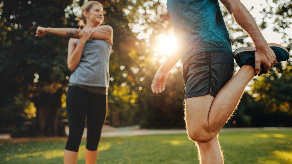 Man and woman exercising in the park