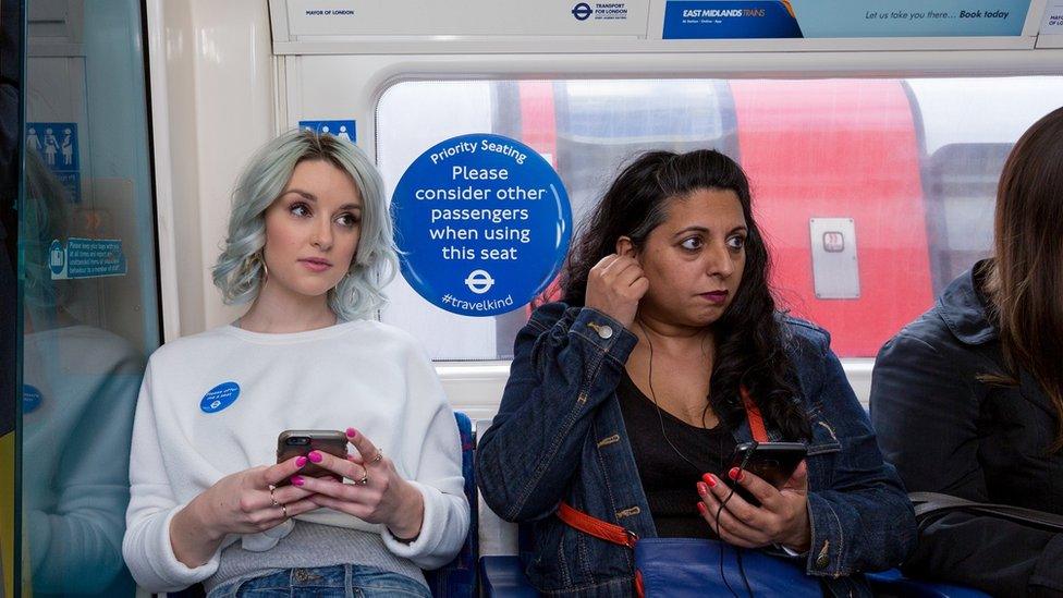 People in priority seats on the Tube