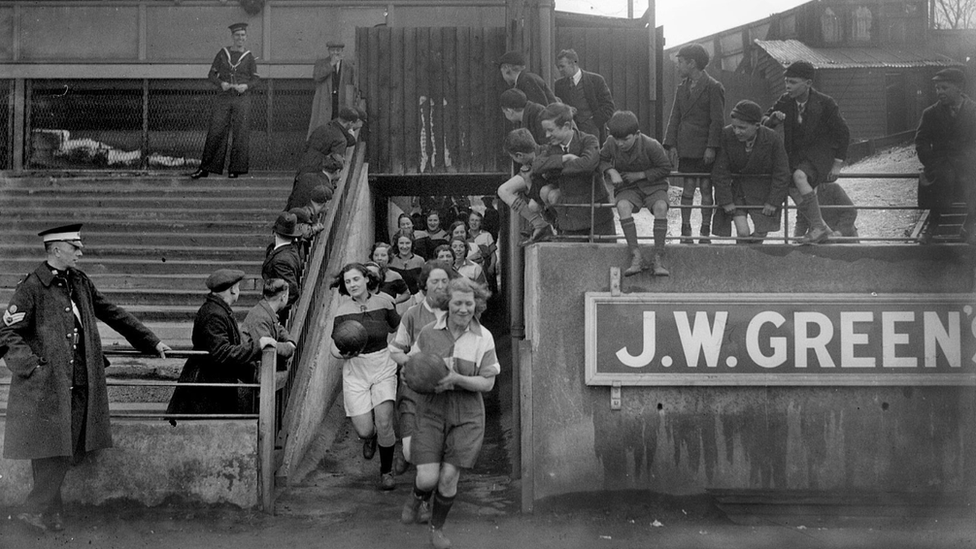 Photo of a ladies' football team running out onto the Luton Town pitch in 1935.