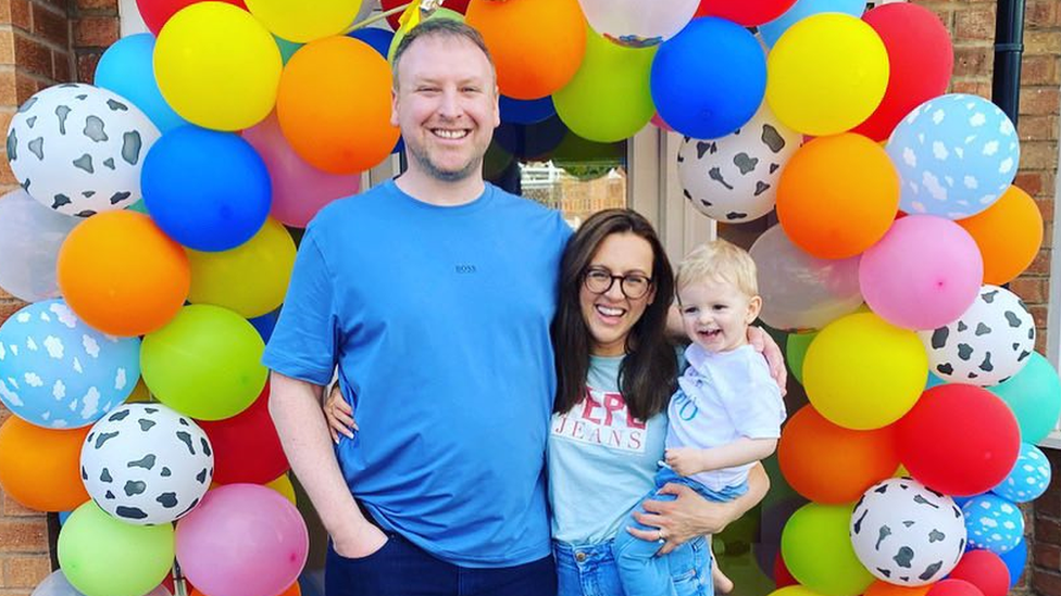 Claire with her husband and two-year-old son George