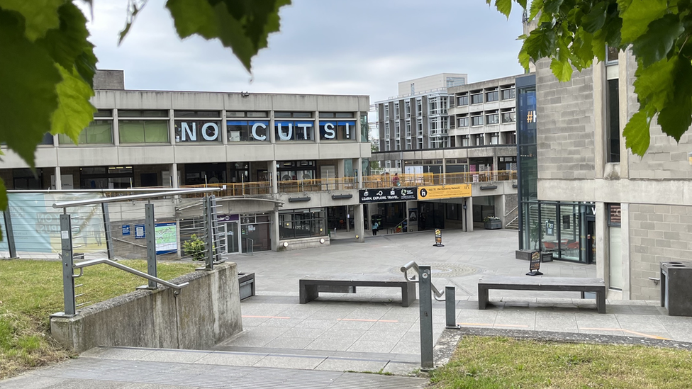 View of UEA campus with NO CUTS spelled out in large letter across windows