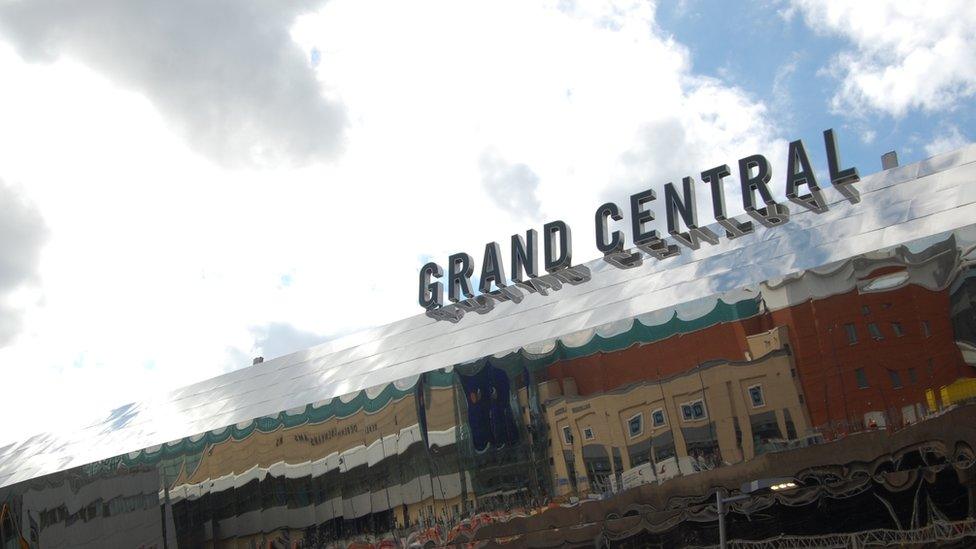 Grand Central sign pictured from below, with clouds passing overhead