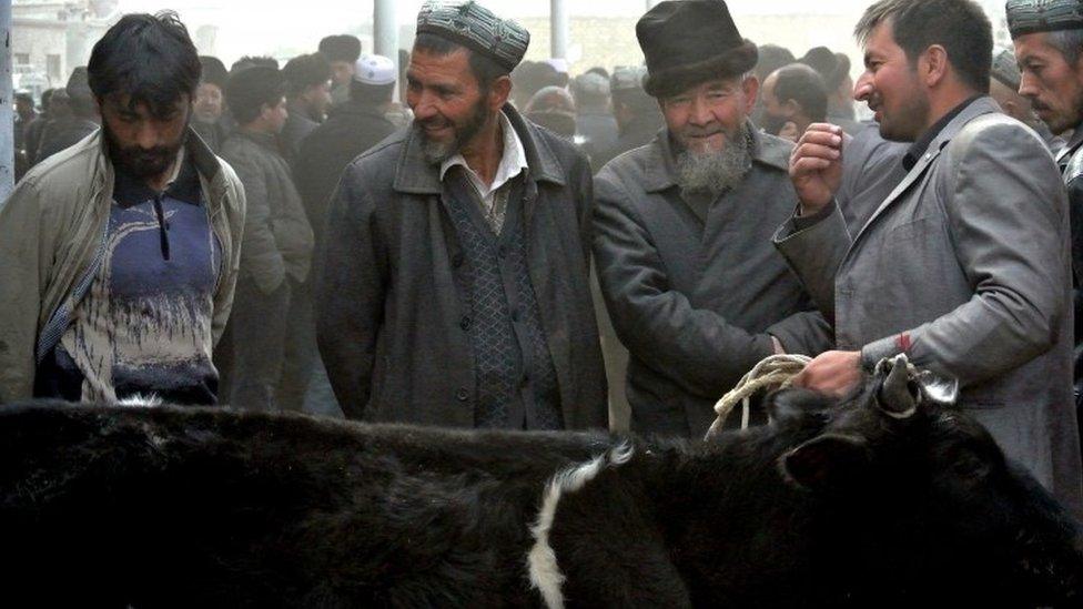 Uighur men at bazaar in Xinjiang province