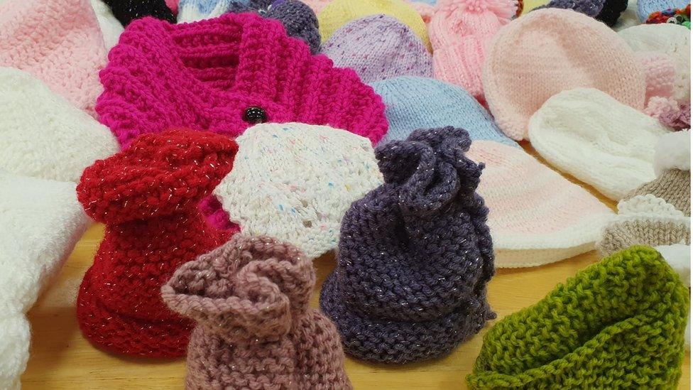 cardigans and hats knitted for refugees by Action Mental Health in Derry