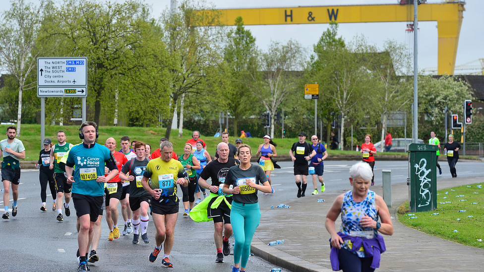 A shipyard crane looms in the background as runners set the pace in east Belfast