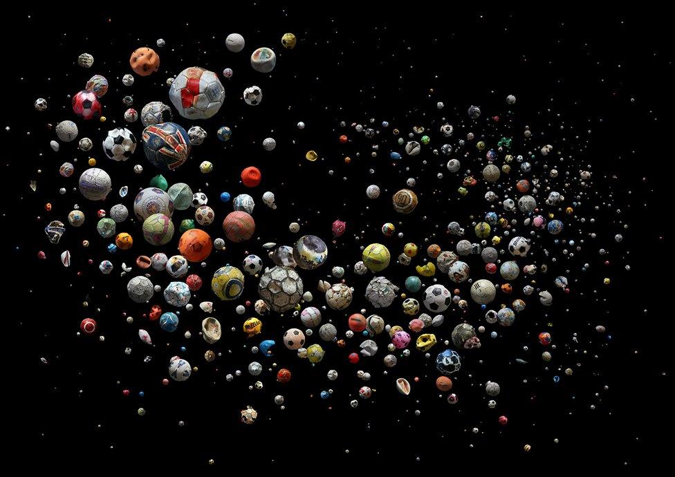 Collection of marine debris footballs against a dark background