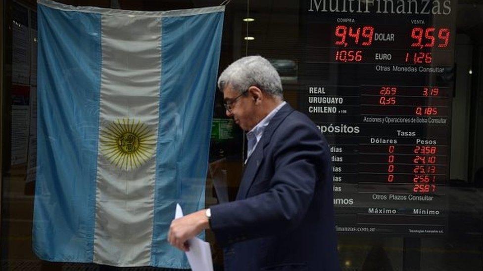 A man walks past a bureau of change in Buenos Aires' downtown on October 13, 2015.