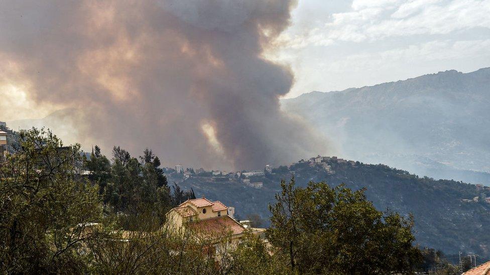 Smoke rises from a wildfire in the Kabylie region