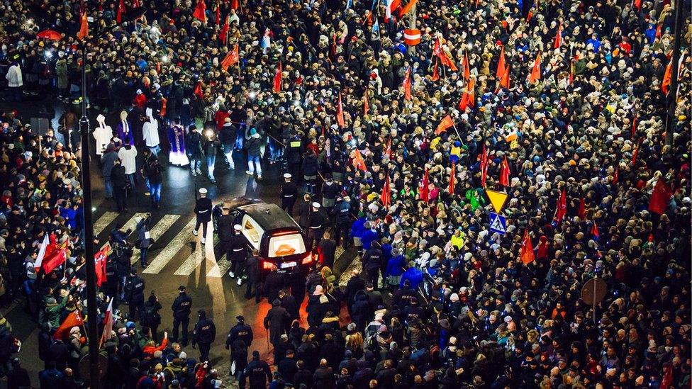 People take part in procession following the coffin of Gdansk mayor Pawel Adamowicz in front of the European Solidarity Centre in Gdansk, 18 January 2019