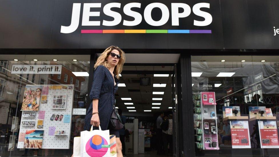 Woman walks past Jessops store