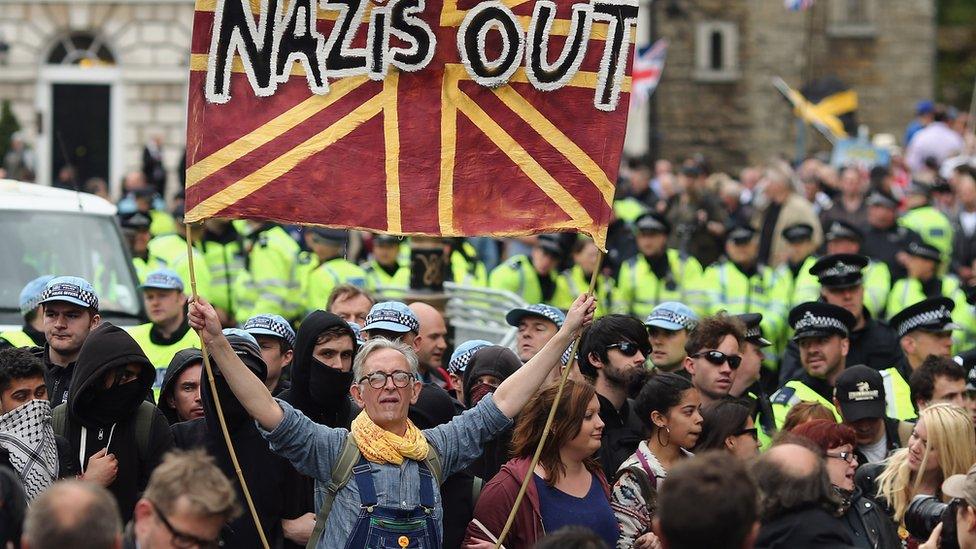 Man holding a nazis out banner