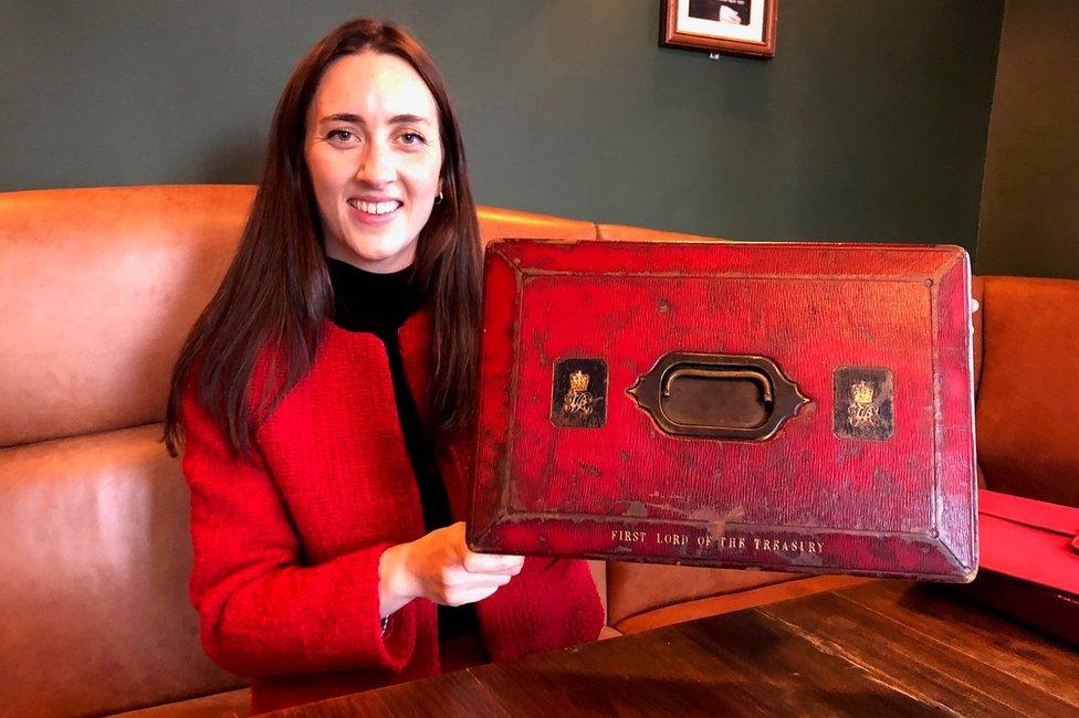 Alice Loxton holding a historic prime minister's despatch box from the 1840s