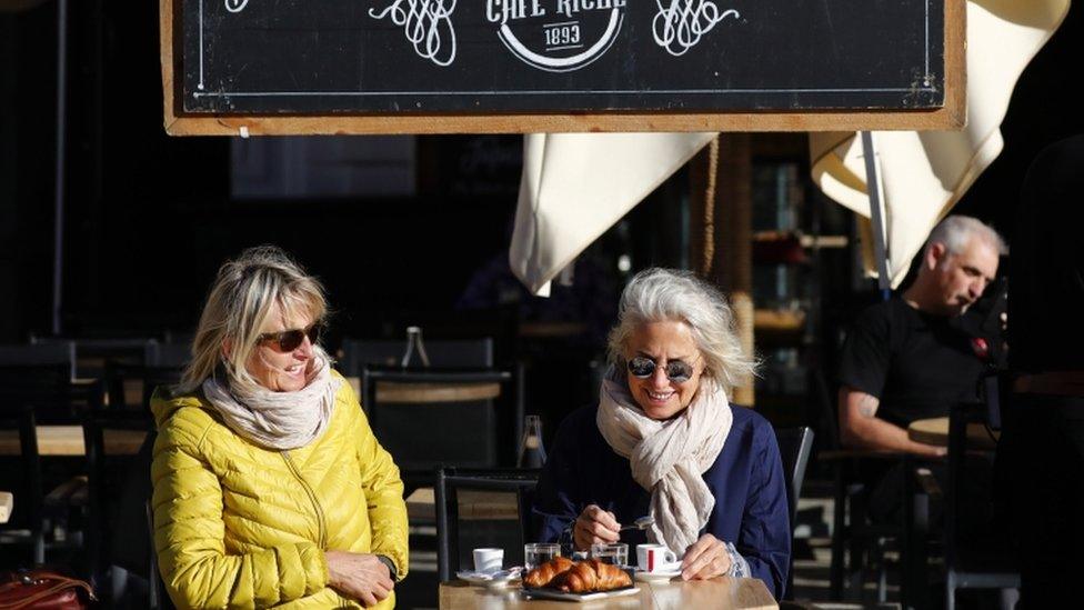 Two women sit at a cafe in Montpellier