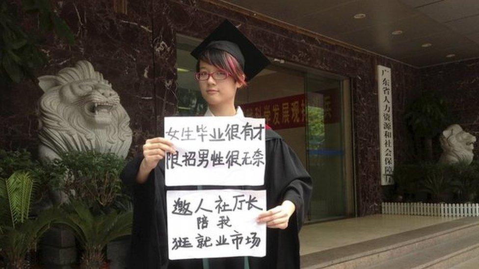 Women activist Zheng Churan, 25, poses for a photograph with papers which read "Women graduates are talented, only hiring men is frustrating" (top) and "I invite the head of Human Resources and Social Security department to go to the job market with me", in this undated file handout picture taken in an unknown location in China, provided by a women's rights group on 8 April 2015.