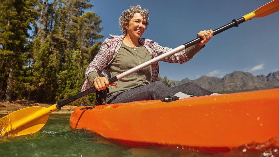 older woman in canoe