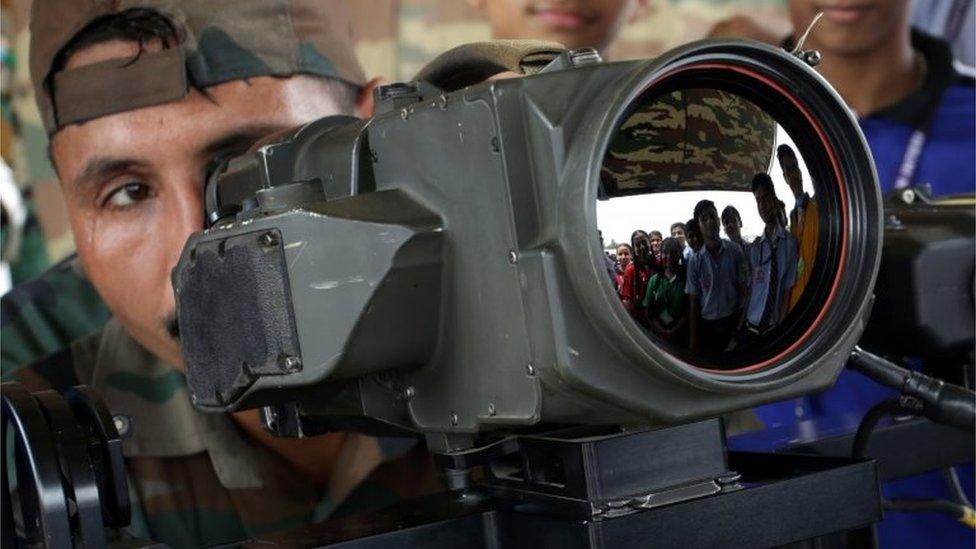 An Indian army soldier explains the function of thermal imaging device to students during a military exhibition in Jammu, the winter capital of Kashmir, India, 10 August 2018.