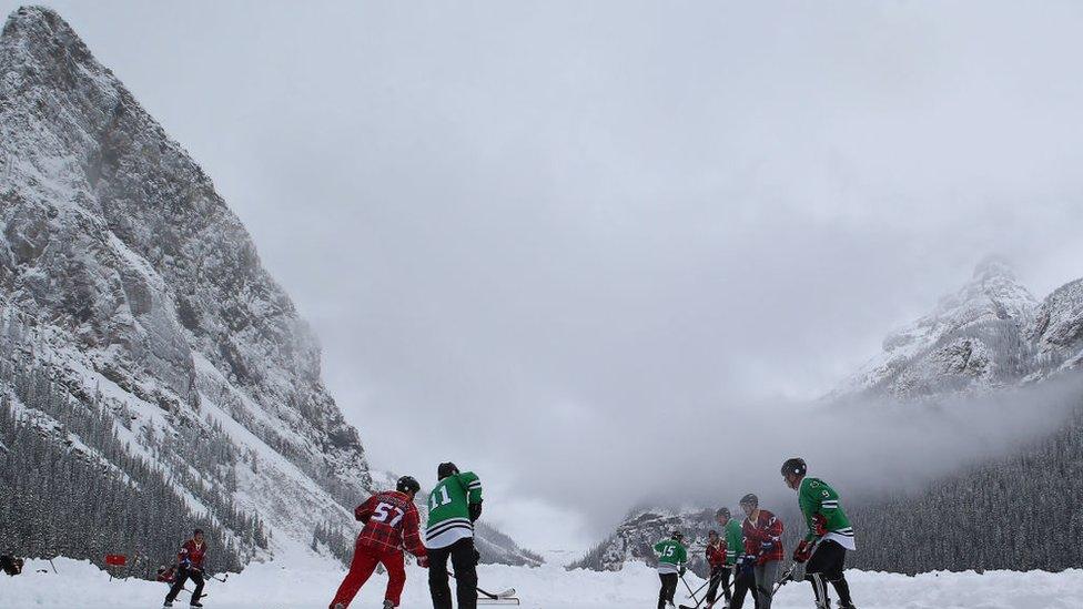 People playing hockey outside