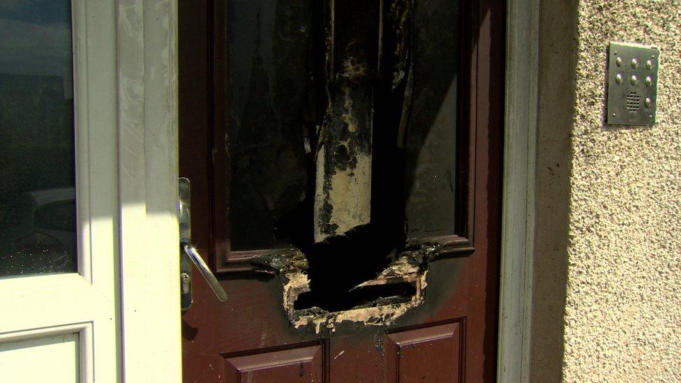 Damage to the front door of the flats in Barra Street