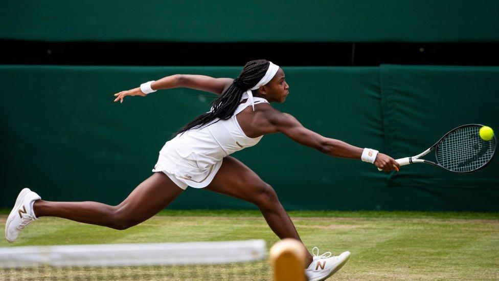 cori gauff reaches for a ball