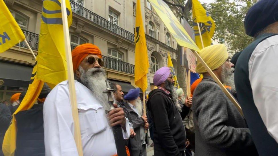 Sikh protestors in London wave yellow flags emblazoned with the word 'Khalistan', the name of an independent Sikh state they are calling for.