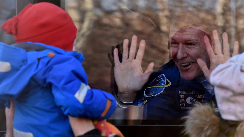 Mr Peake waves from a bus during a sending-off ceremony