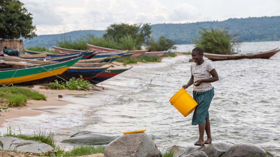 Woman on edge of Lake Victoria