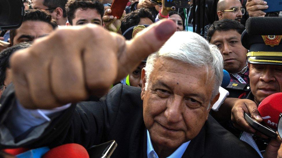 Mexico's presidential candidate Andres Manuel Lopez Obrador for the "Juntos haremos historia" party, gives his thumb up while leaving the polling station during general elections, in Mexico City, on July 1, 2018.