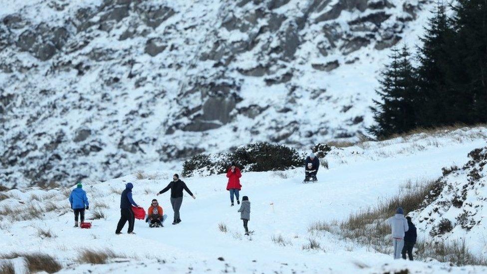 People enjoy the snow in the Wicklow Gap in County Wicklow, Ireland.