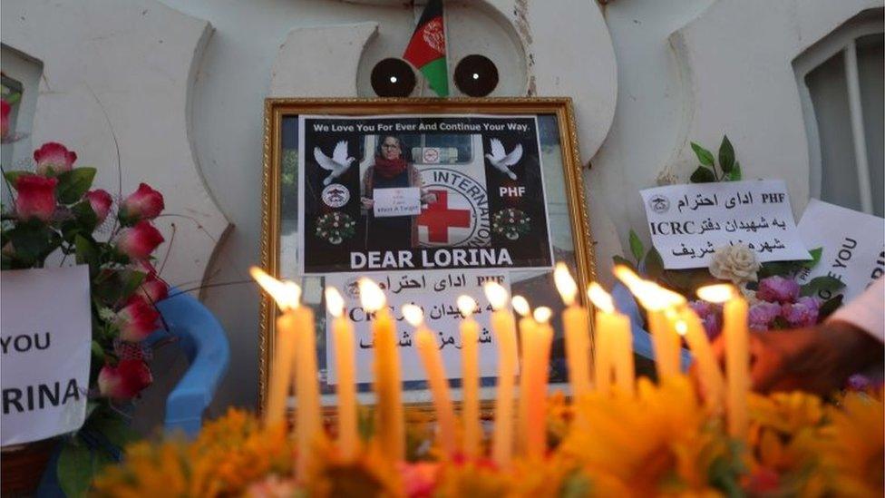 People in Herat light candles and hold placards to condemn the killing of a Spanish ICRC aid worker, 16 September 2017