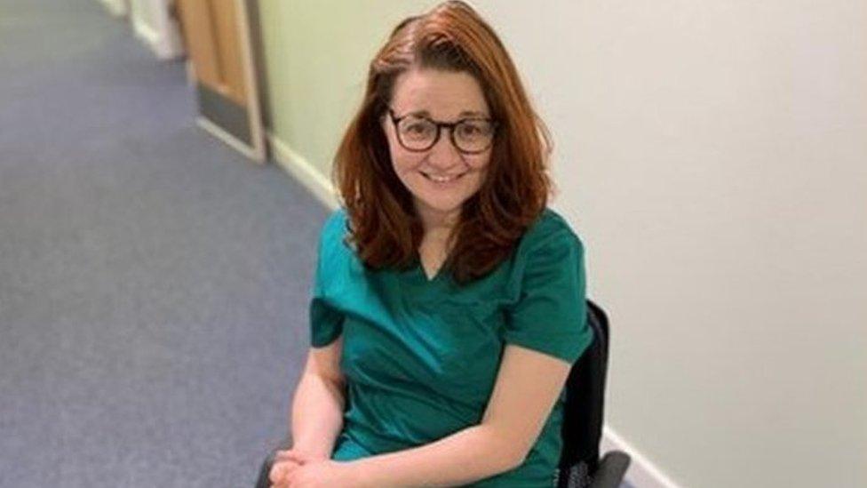 Dr Hannah Barham-Brown in her wheelchair and scrubs