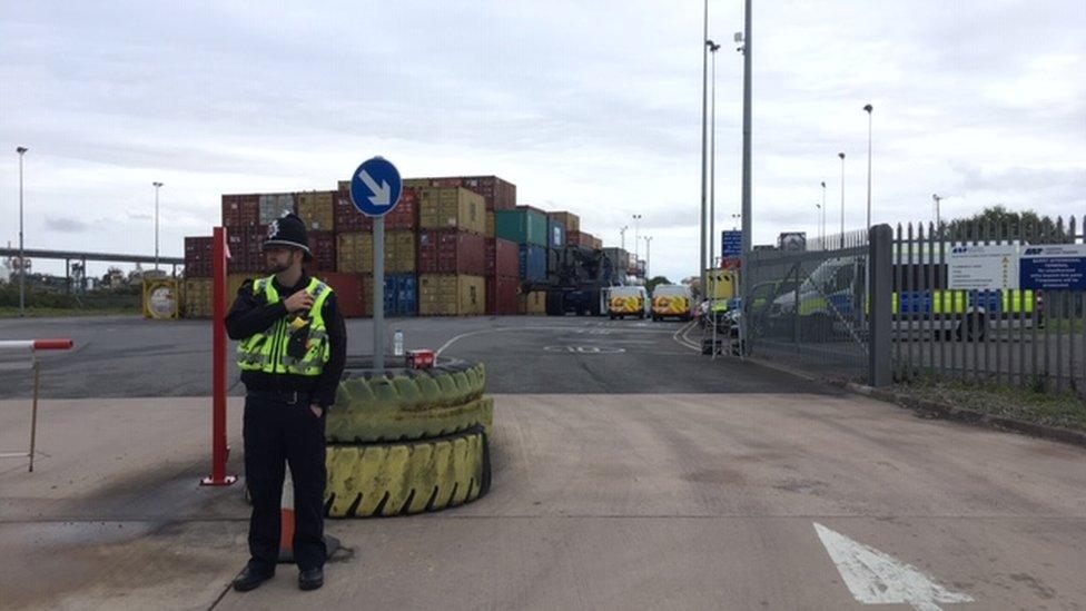 Police officer standing outside freight terminal