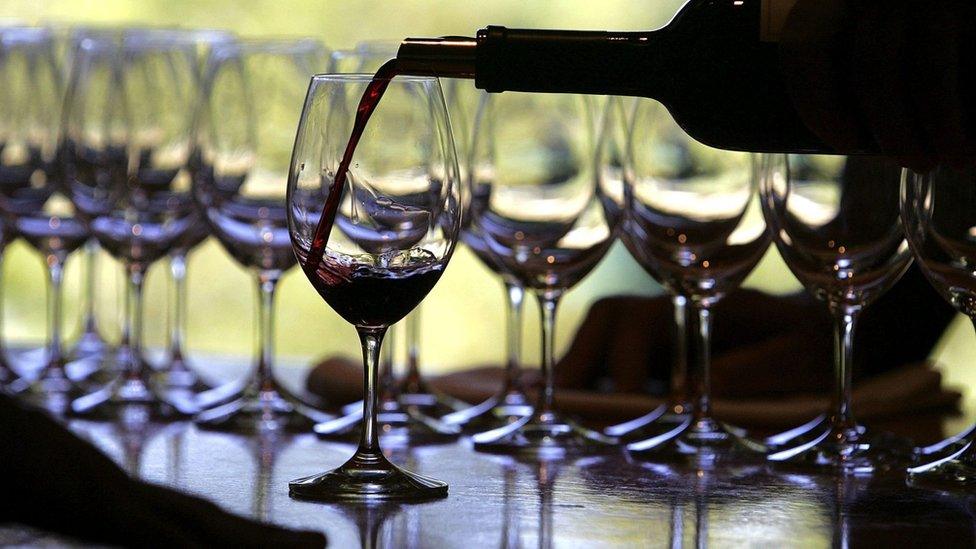 Red wine being poured into glasses