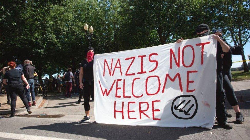 Antifa protesters with a "Nazis not welcome here" banner