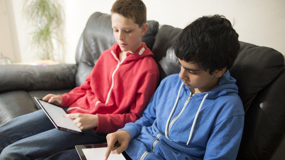 boys using blank tablets indoors