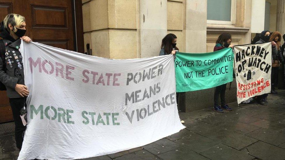 Supporters outside court holding banners