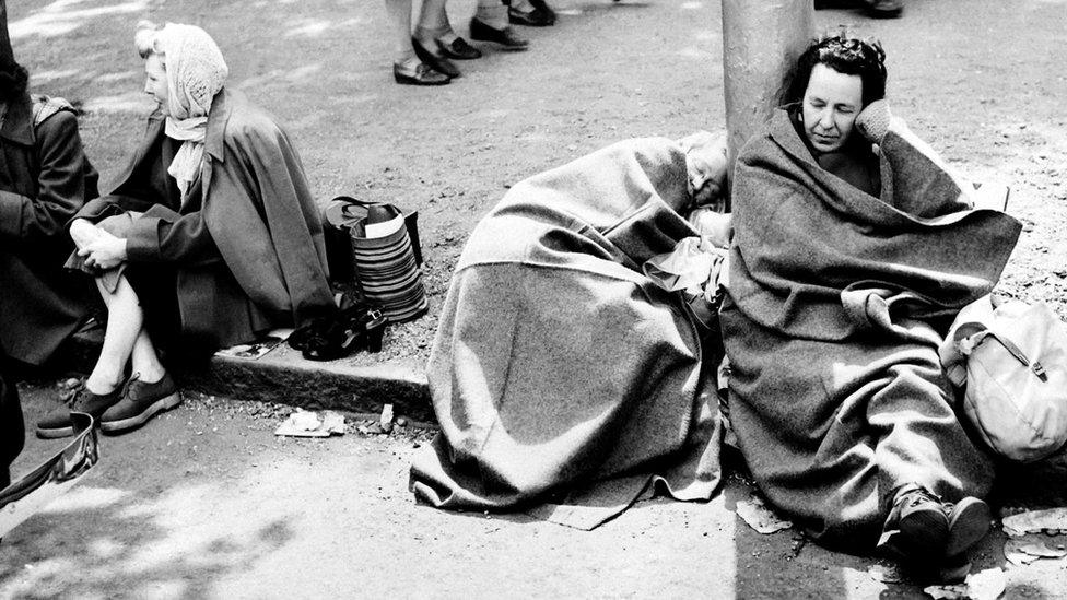 Some women sleep, on June 1, 1953 , as they wait on the royal route on the eve of Britain Queen Elizabeth II's coronation