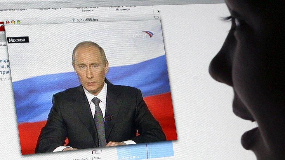 A girl watches Russian President Vladimir Putin's address to the nation on Russian TV Channel One's website