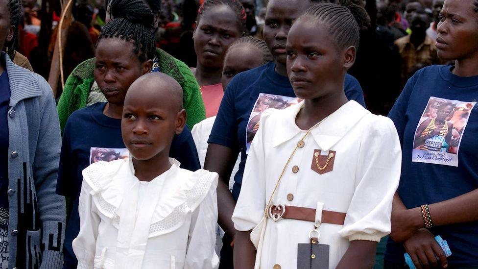 Two young girls dressed in white