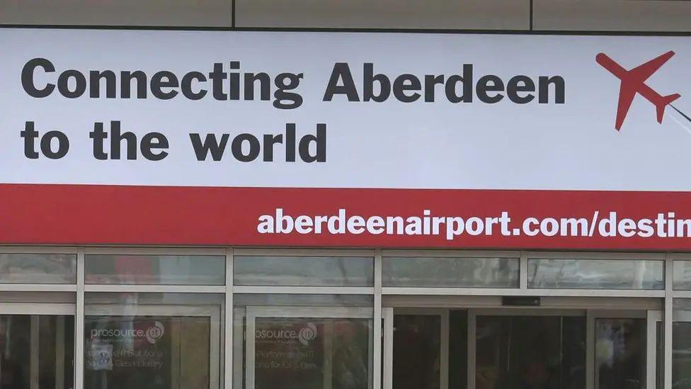 'Connecting Aberdeen to the world' sign at Aberdeen Airport.