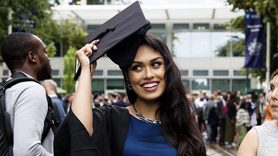 Bhasha in a graduation cap and gown