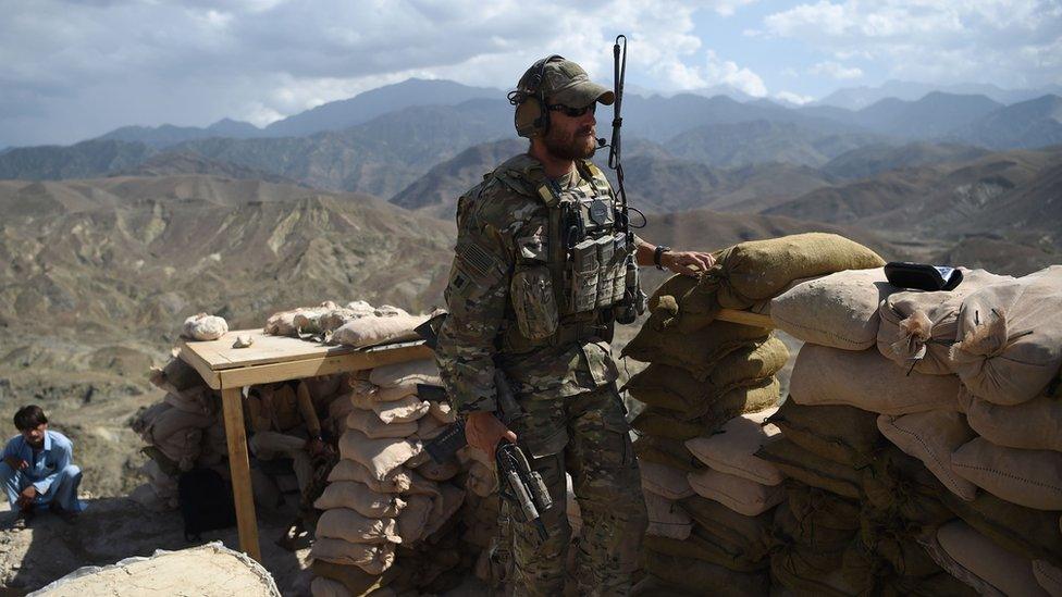 In this photo taken on July 7, 2018, a US Army soldier from Nato and an Afghan Local Police (ALP) officer are seen in a checkpoint