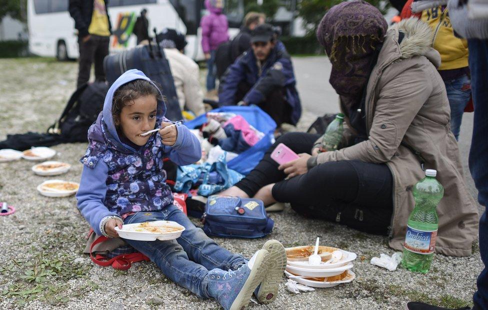 A young girl from Syria eats a meal at a refugee facility in Munich, Germany