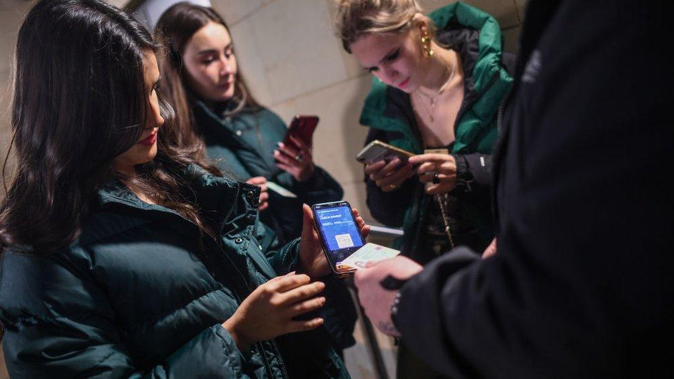 EDINBURGH, SCOTLAND - NOVEMBER 25: A group of women show their COVID passports as they enter La Belle Angele nightclub on November 25, 2021 in Edinburgh, Scotland.