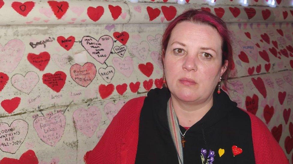 Susie standing in front of the Covid memorial wall.